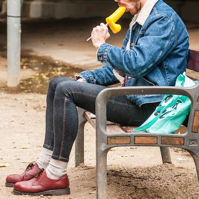 12P Gay brunette Victor A erotically sucks a sex toy lollipop on a public bench