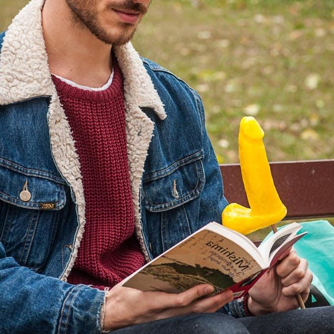 12P Gay brunette Victor A erotically sucks a sex toy lollipop on a public bench