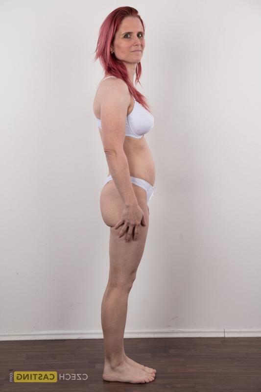 20P Redhead amateur Kveta shows her mismatched breasts while standing naked