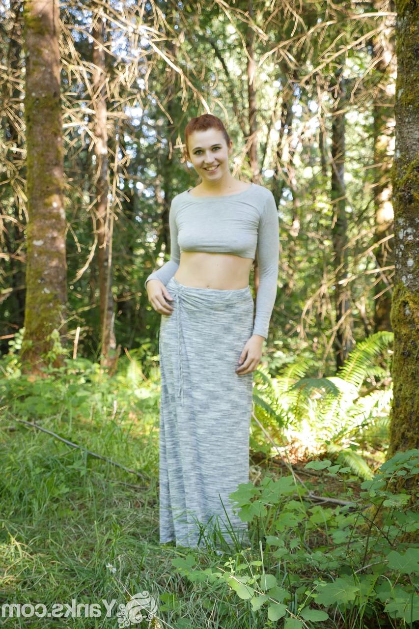 17P Pale redhead Stephie Staar rubs her pink pussy in a clearing in the forest
