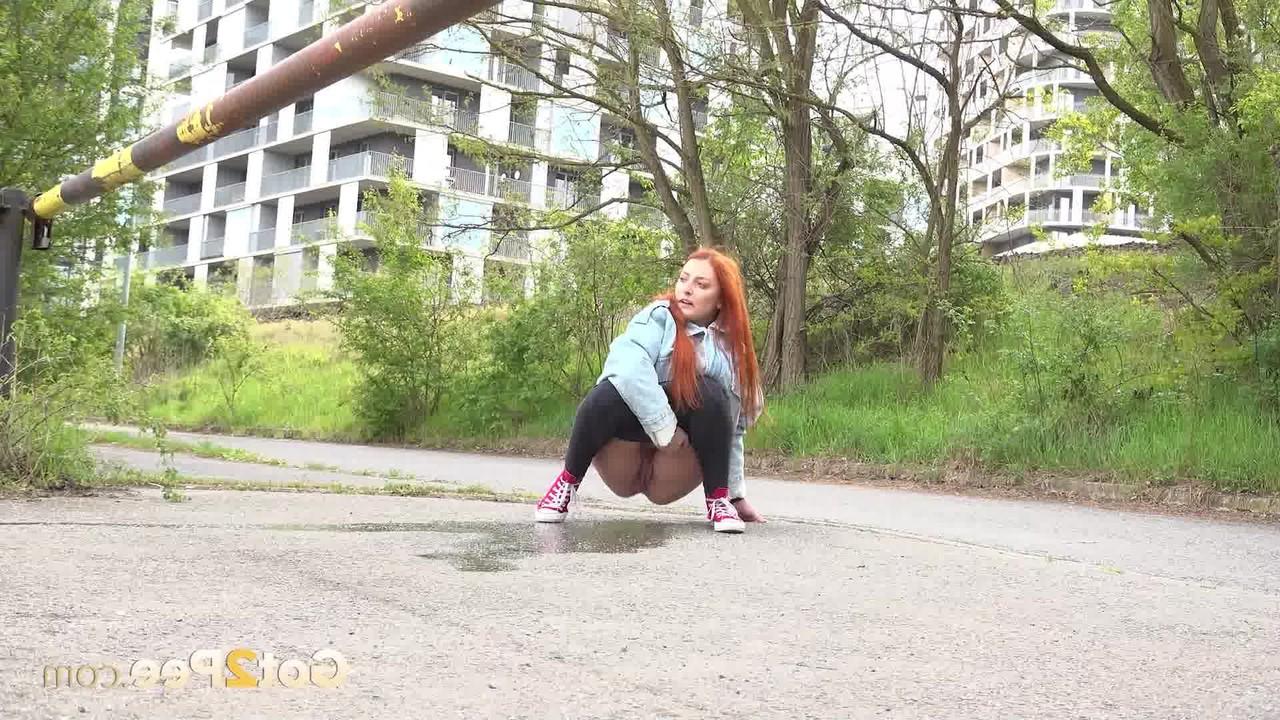 15P Natural redhead Katy Rose takes a badly needed piss on a paved road