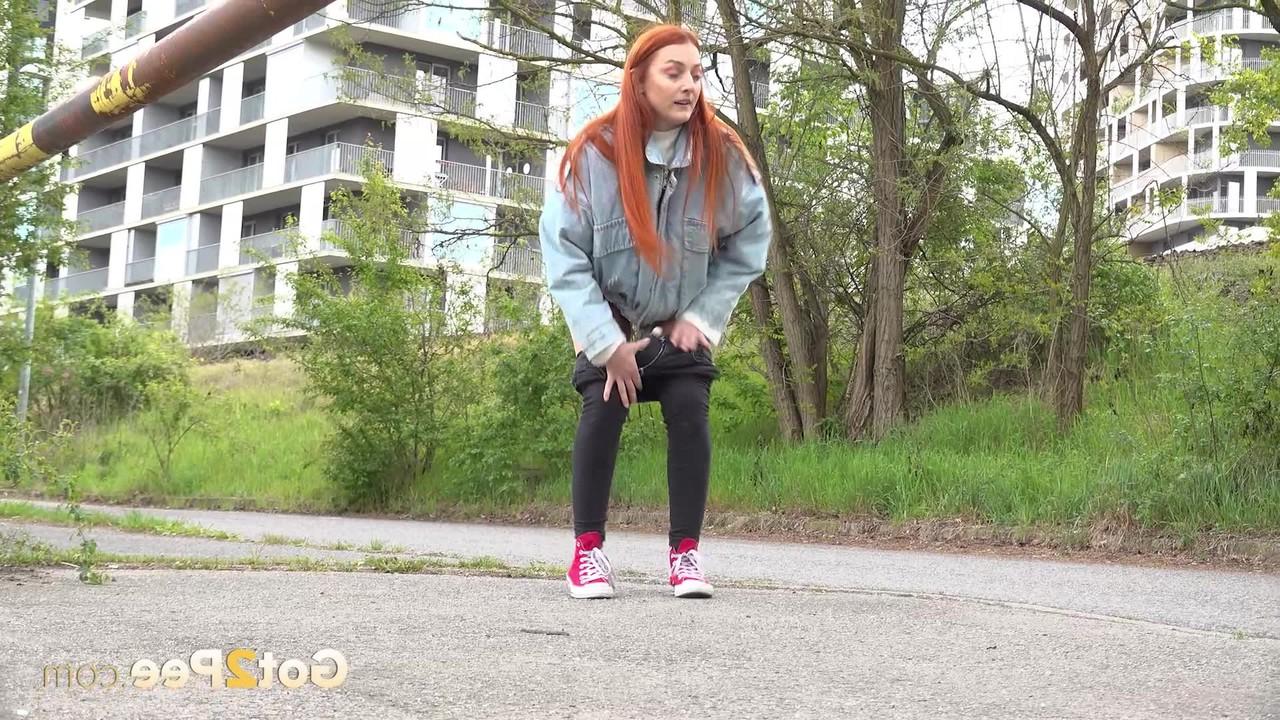 15P Natural redhead Katy Rose takes a badly needed piss on a paved road