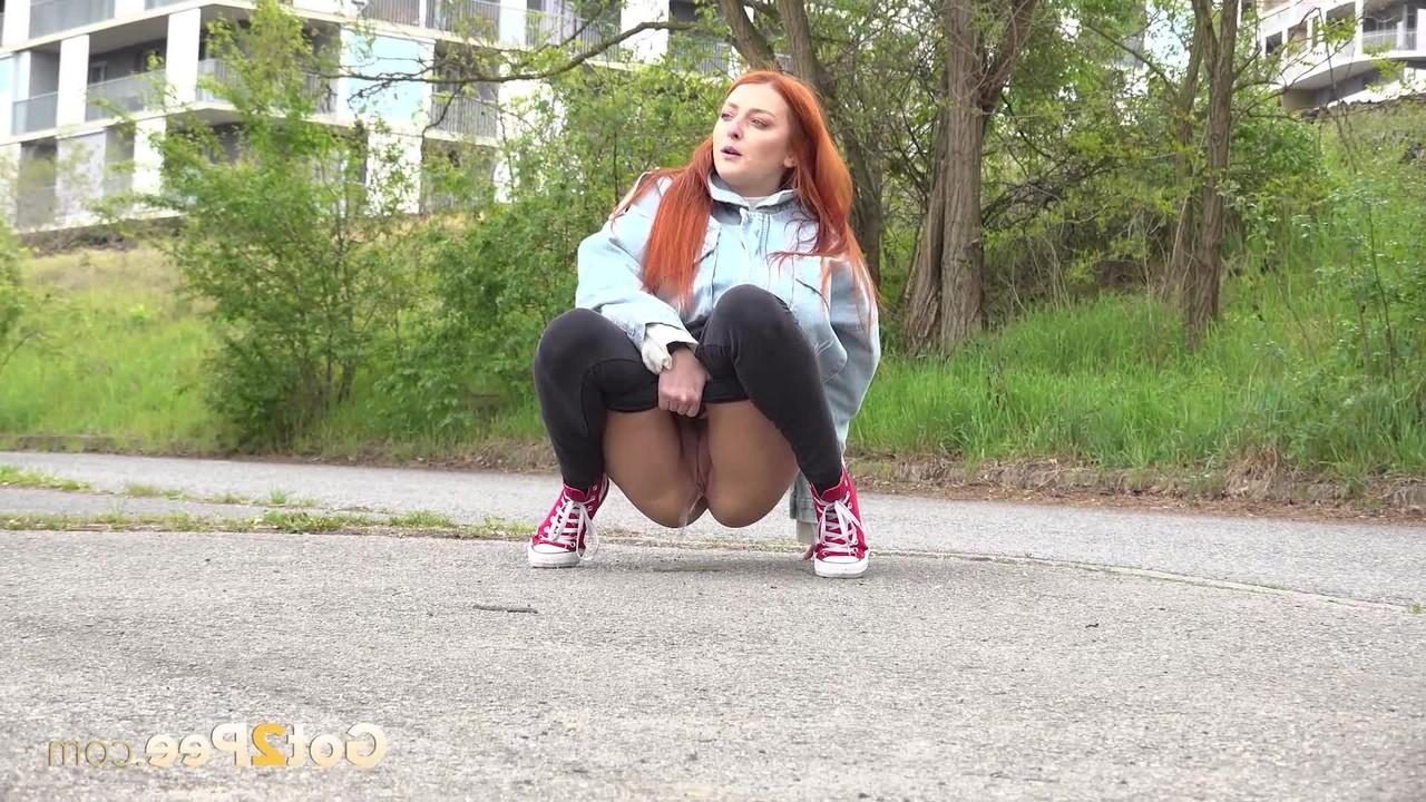 15P Natural redhead Katy Rose takes a badly needed piss on a paved road