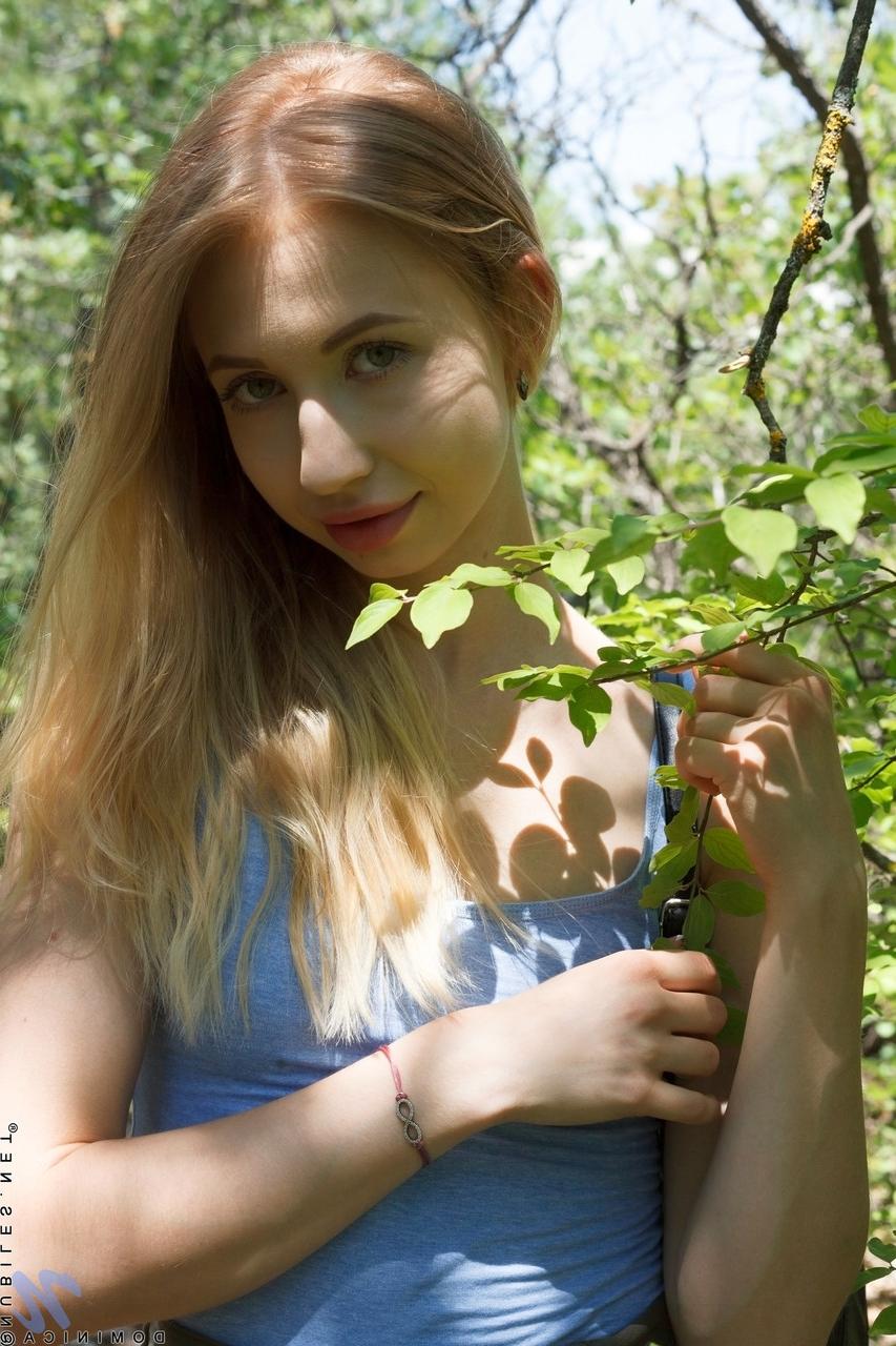20P Long-haired babe Dominica stripping and fingering herself in the forest