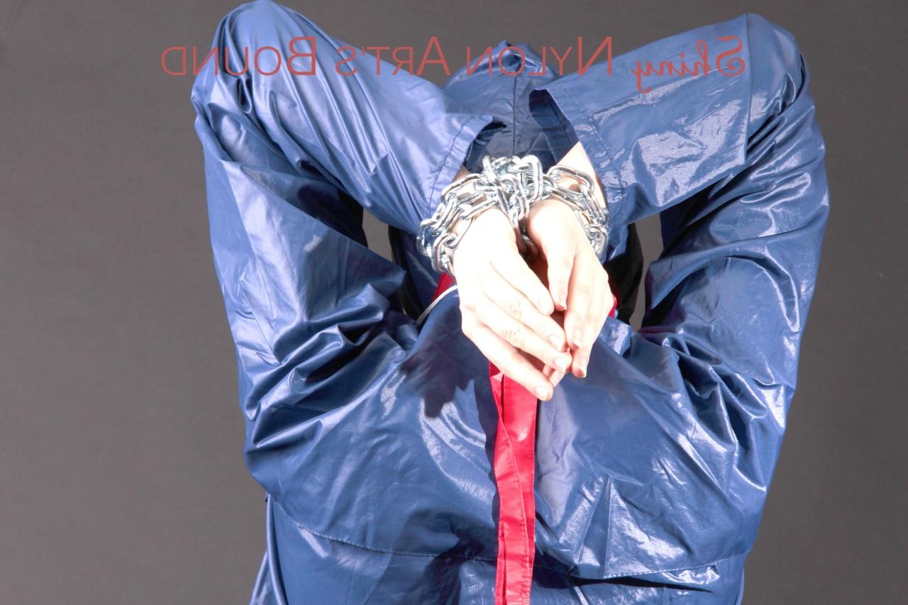 16P Caucasian female is restrained and gagged in a raincoat and rubber boots