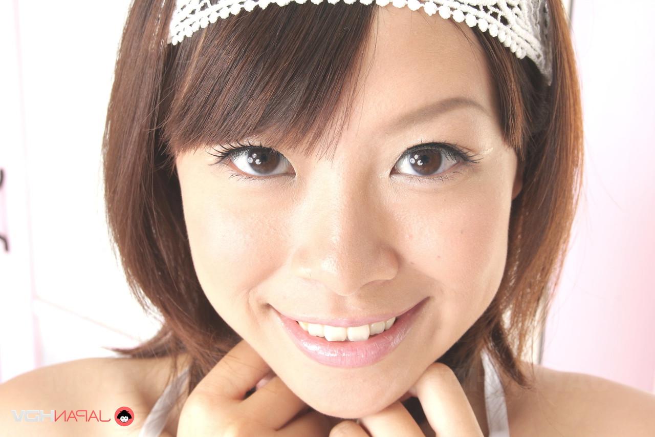15P Adorable Japanese girl Saki Aimi frees her tits from a bikini top