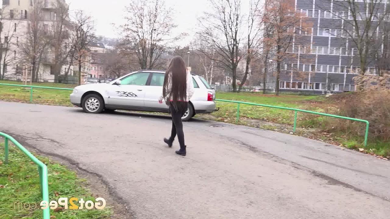 15P Caucasian girl Lara Fox squats for a badly needed pee upon a paved roadway