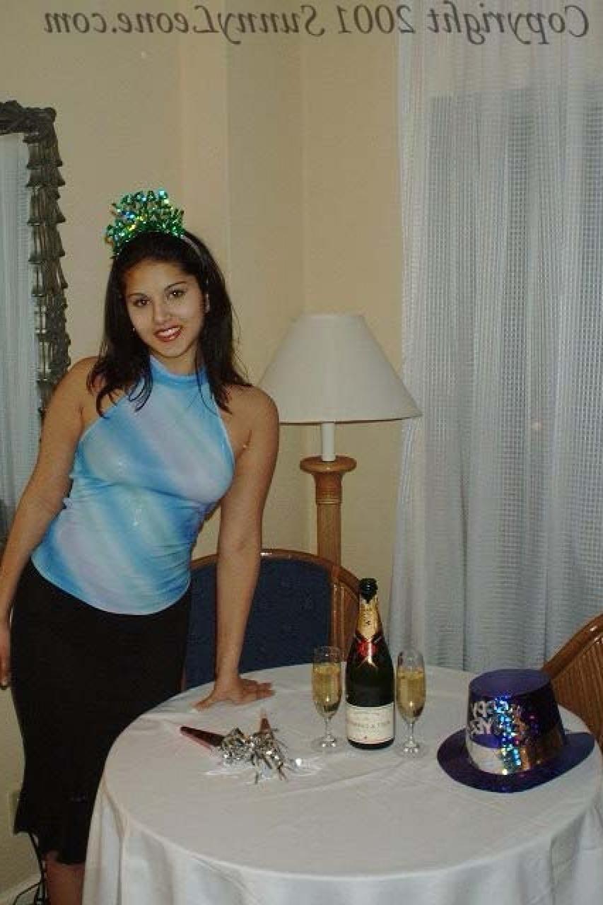 11P La jolie star du porno indienne Sunny Leone dévoile son cul et se masturbe sur une table.