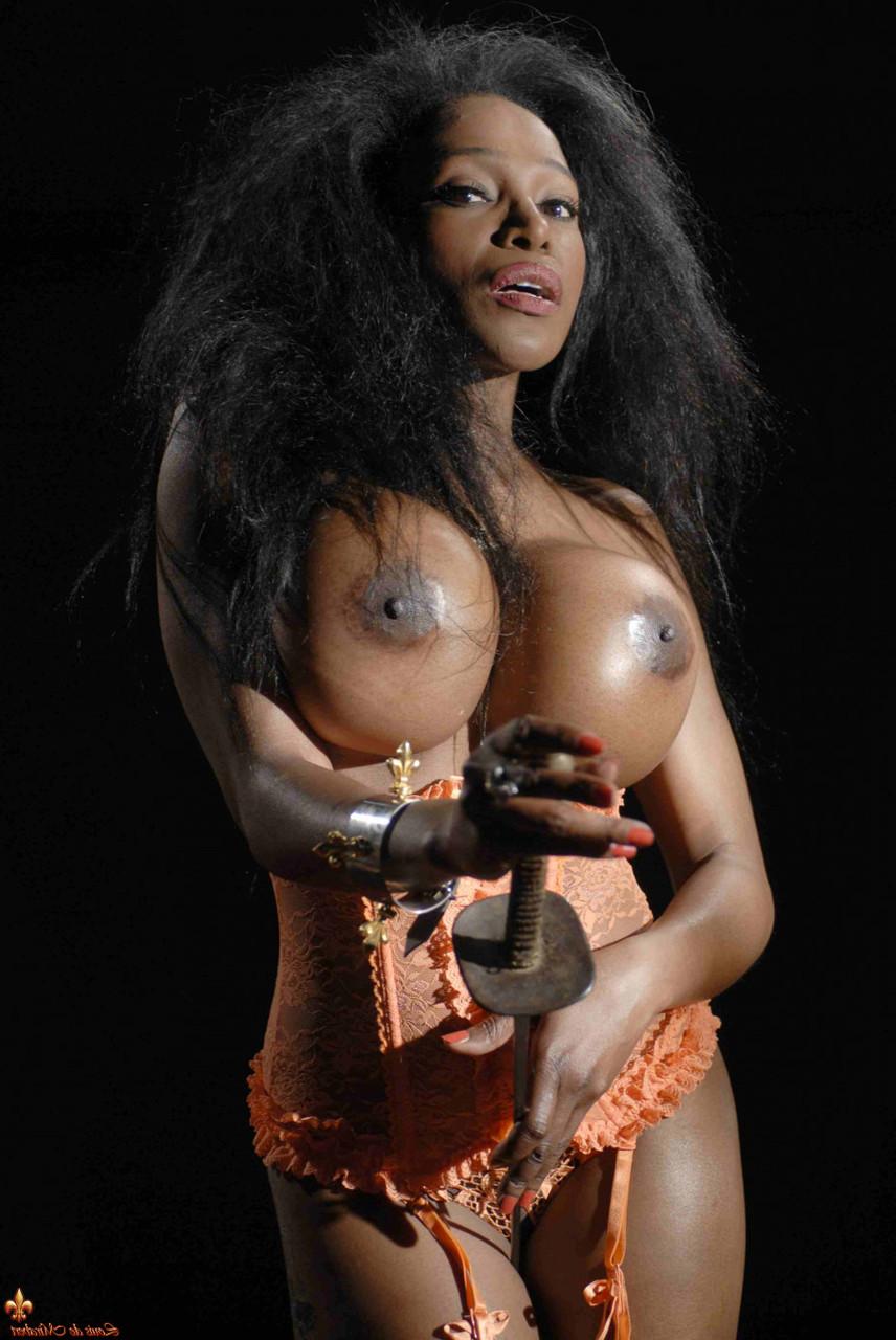16P Ebony model Felina displays her augmented breasts while wearing lingerie