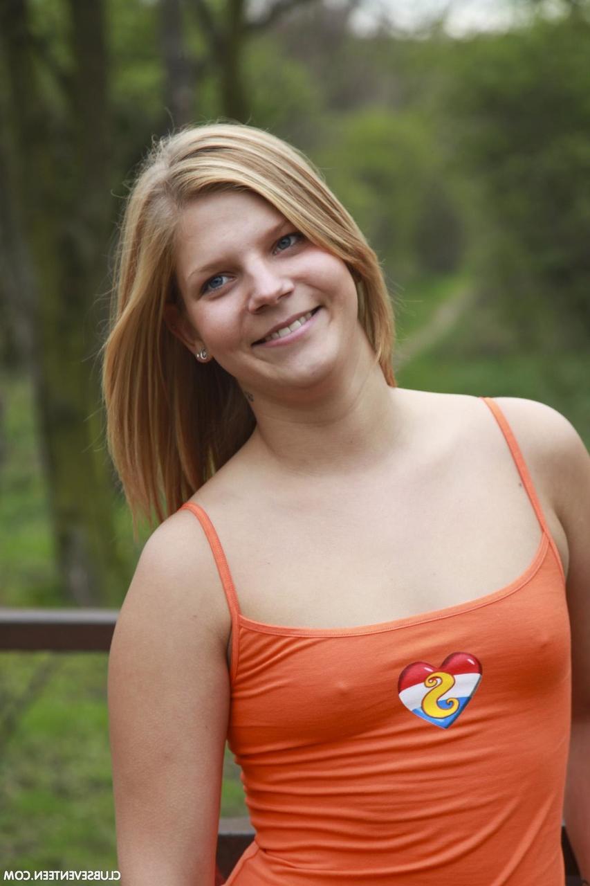 20P Dutch babe Dee exposes her big booty and small tits in the park