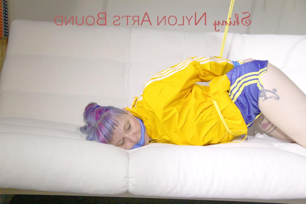 16P Fair skinned girl is left tied up and gagged in nylon athletic wear