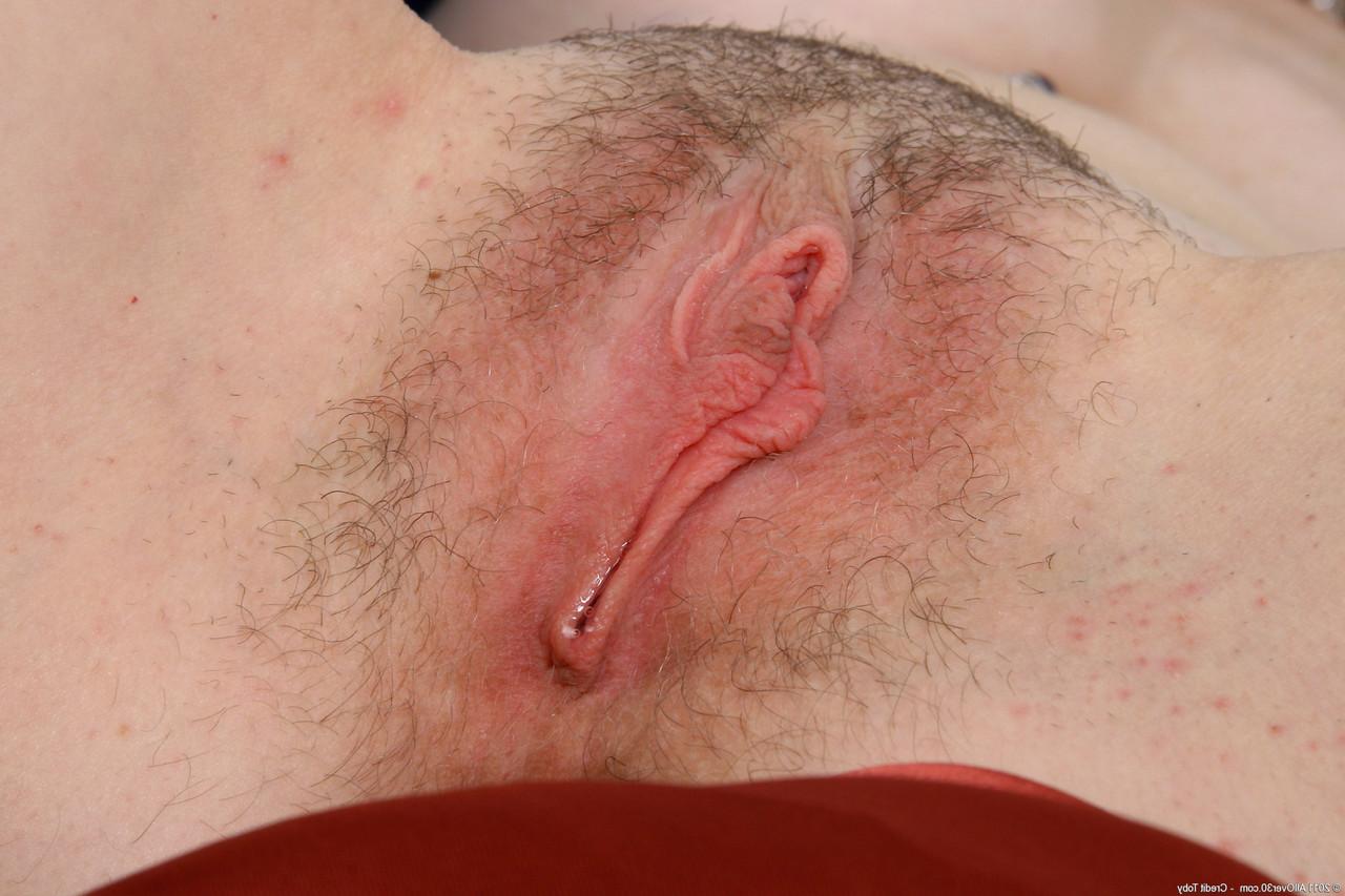 20P Curly-haired MILF Lilly shows her big tits and hairy holes in a solo