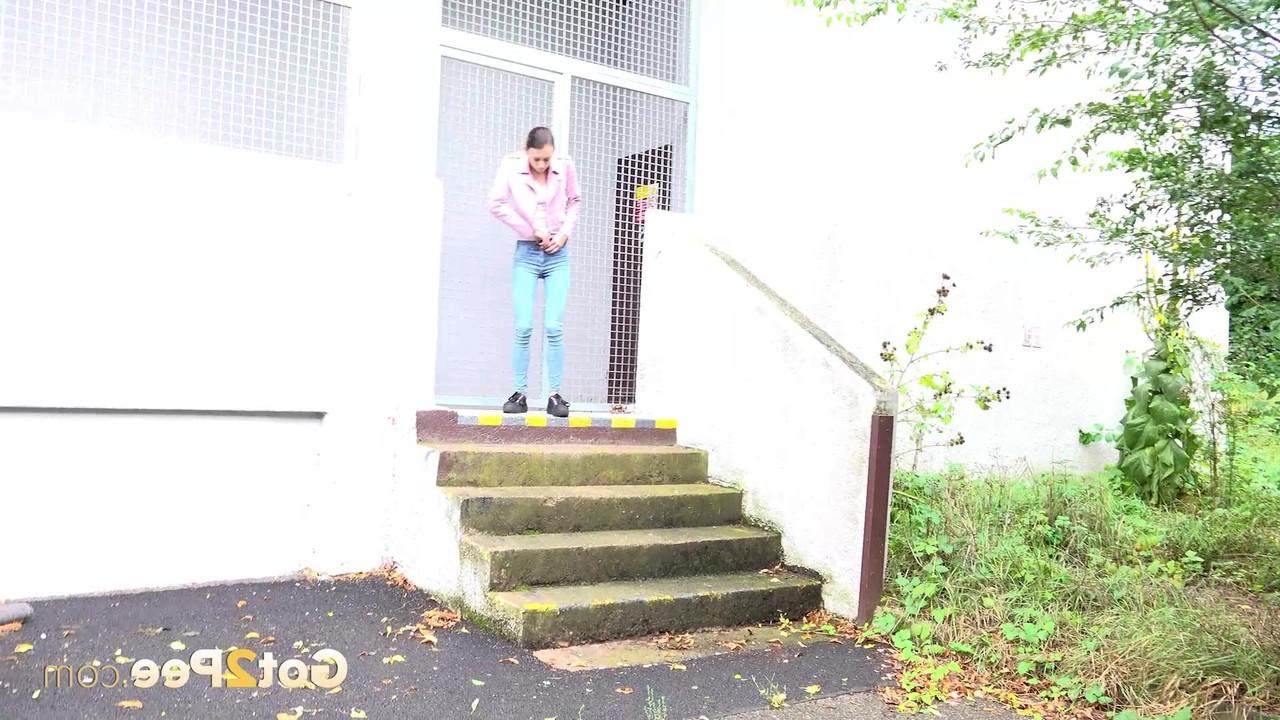 15P Young girl Adele Unicorn pulls down blue jeans to pee on a set of public steps