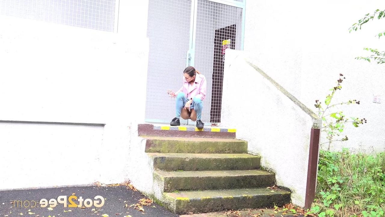 15P Young girl Adele Unicorn pulls down blue jeans to pee on a set of public steps