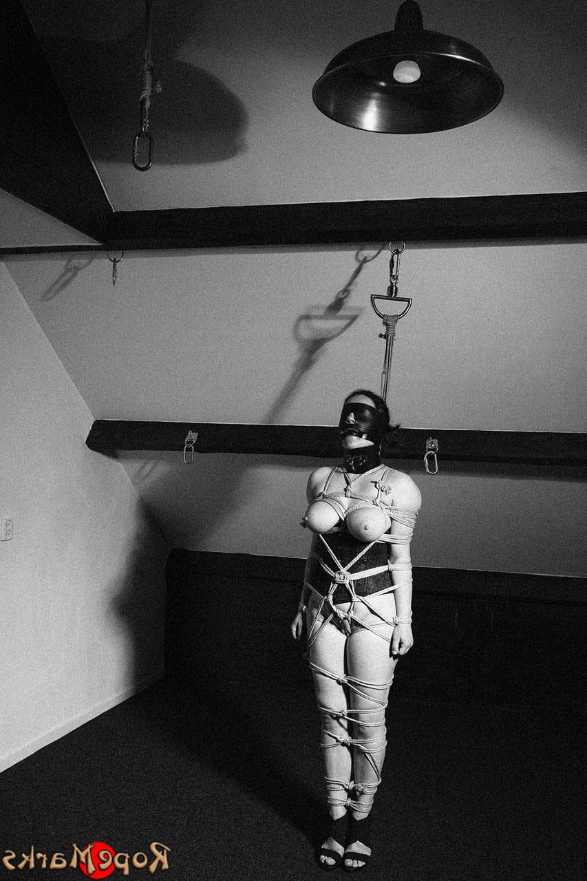 15P Caucasian female is restrained with ropes in a black latex hood