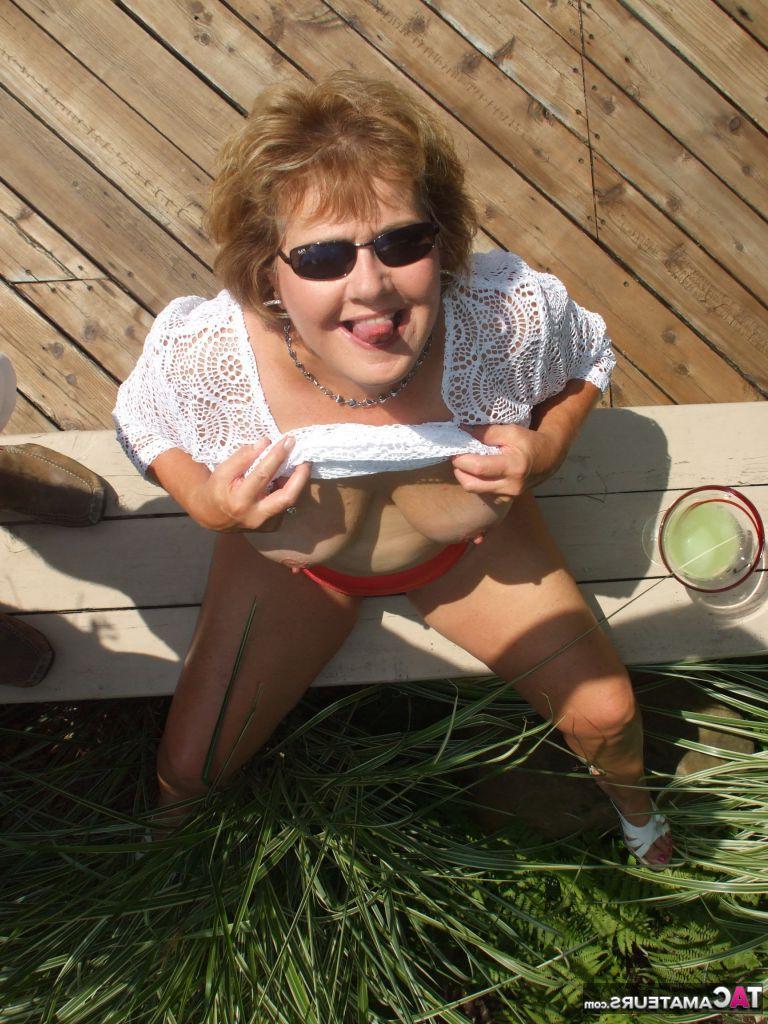 19P Mature amateur BustyBliss goes topless while enjoying a glass of booze
