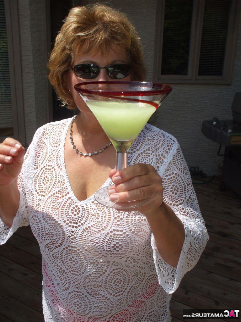 19P Mature amateur BustyBliss goes topless while enjoying a glass of booze