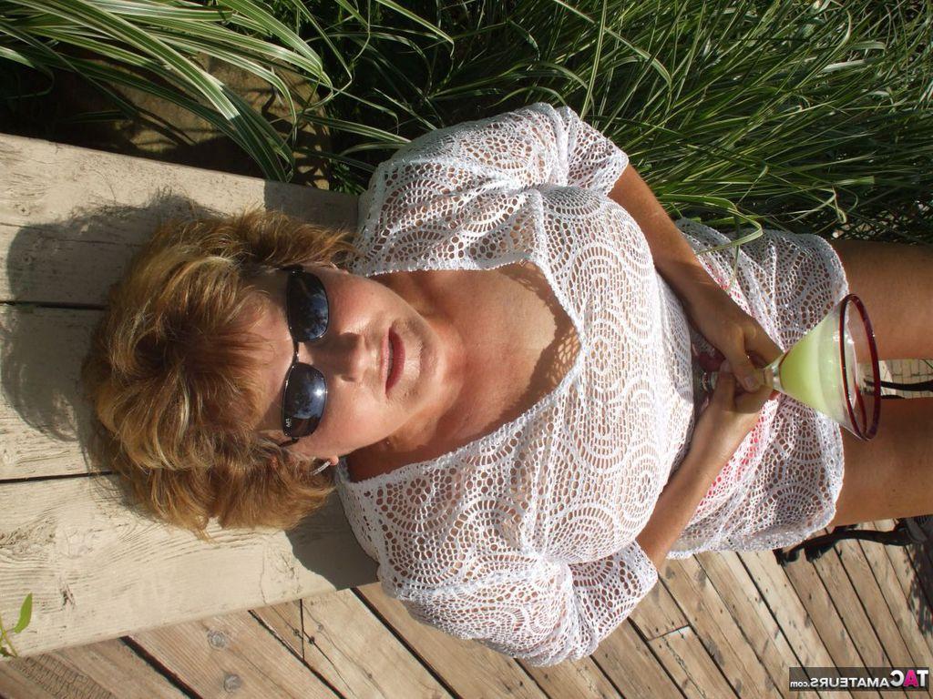 19P Mature amateur BustyBliss goes topless while enjoying a glass of booze