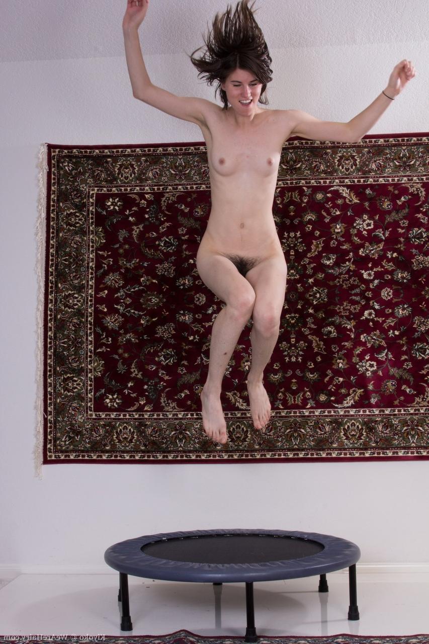 20P Tall amateur girl Kiyoko shows her small tits and hairy muff on the trampoline