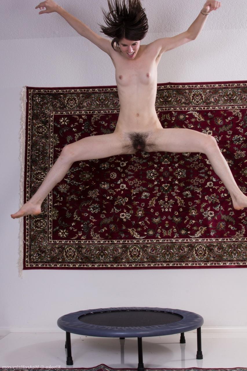 20P Tall amateur girl Kiyoko shows her small tits and hairy muff on the trampoline