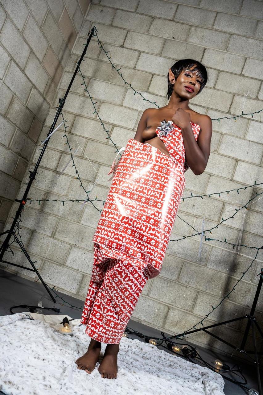 20P Slim ebony with elf ears Britney Siren upacks herself from a decorative paper