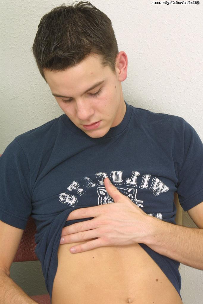 20P Gay brunette Trent Williams strips down naked and gently strokes his cut dick