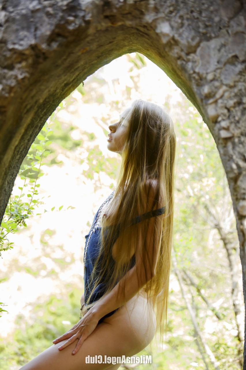 15P Skinny babe Milena Angel undressing and posing butt naked in the forest