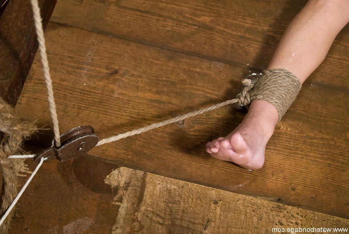20P Tiny boobed brunette Wenona engages in intense wet bondage action