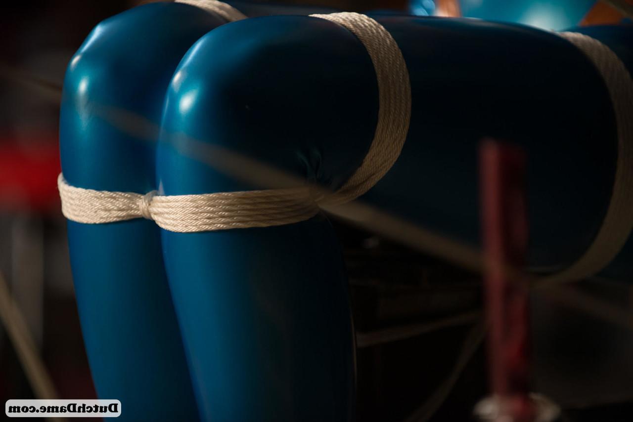 16P Latex attired female is is kept in captivity by rope bindings