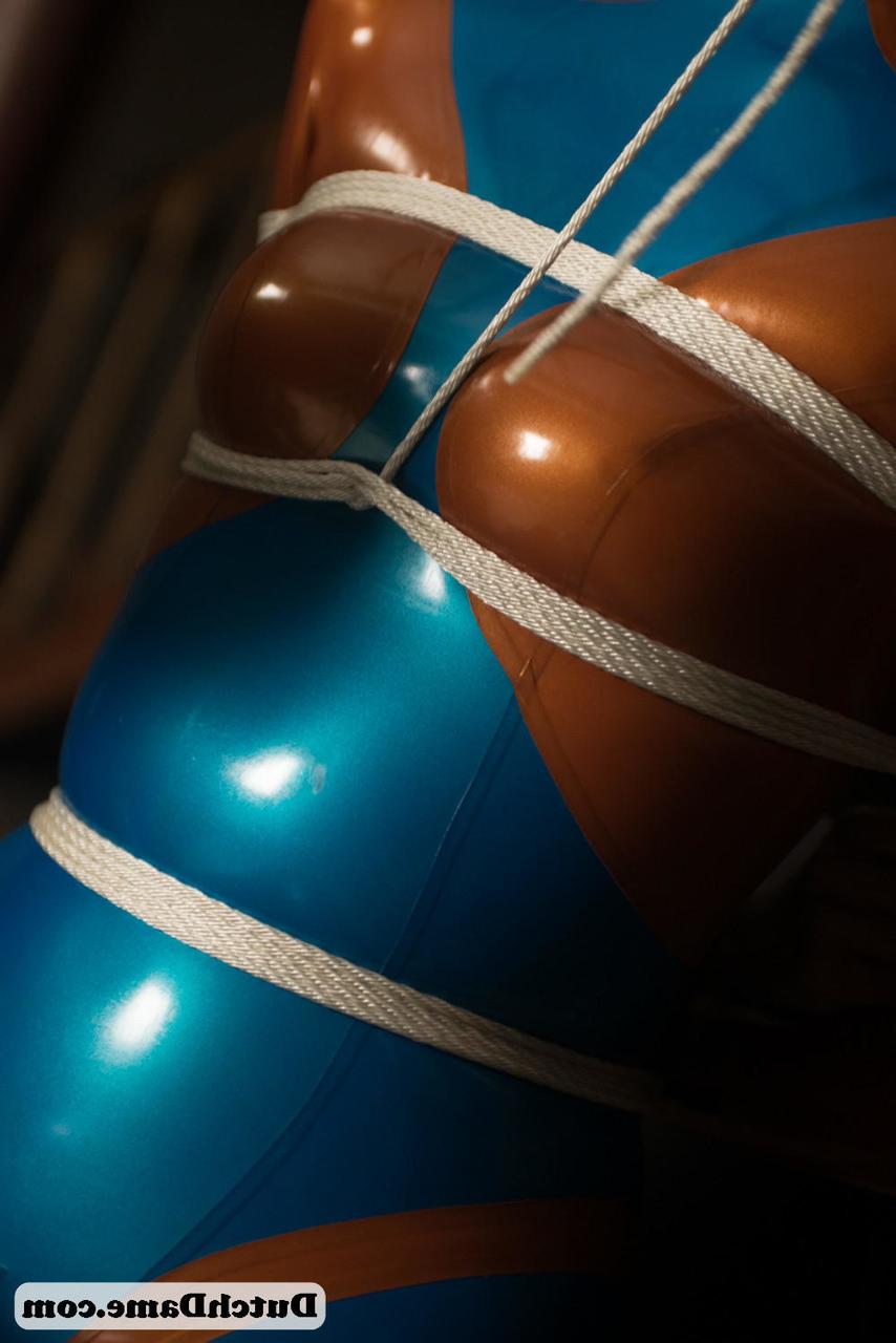 16P Latex attired female is is kept in captivity by rope bindings