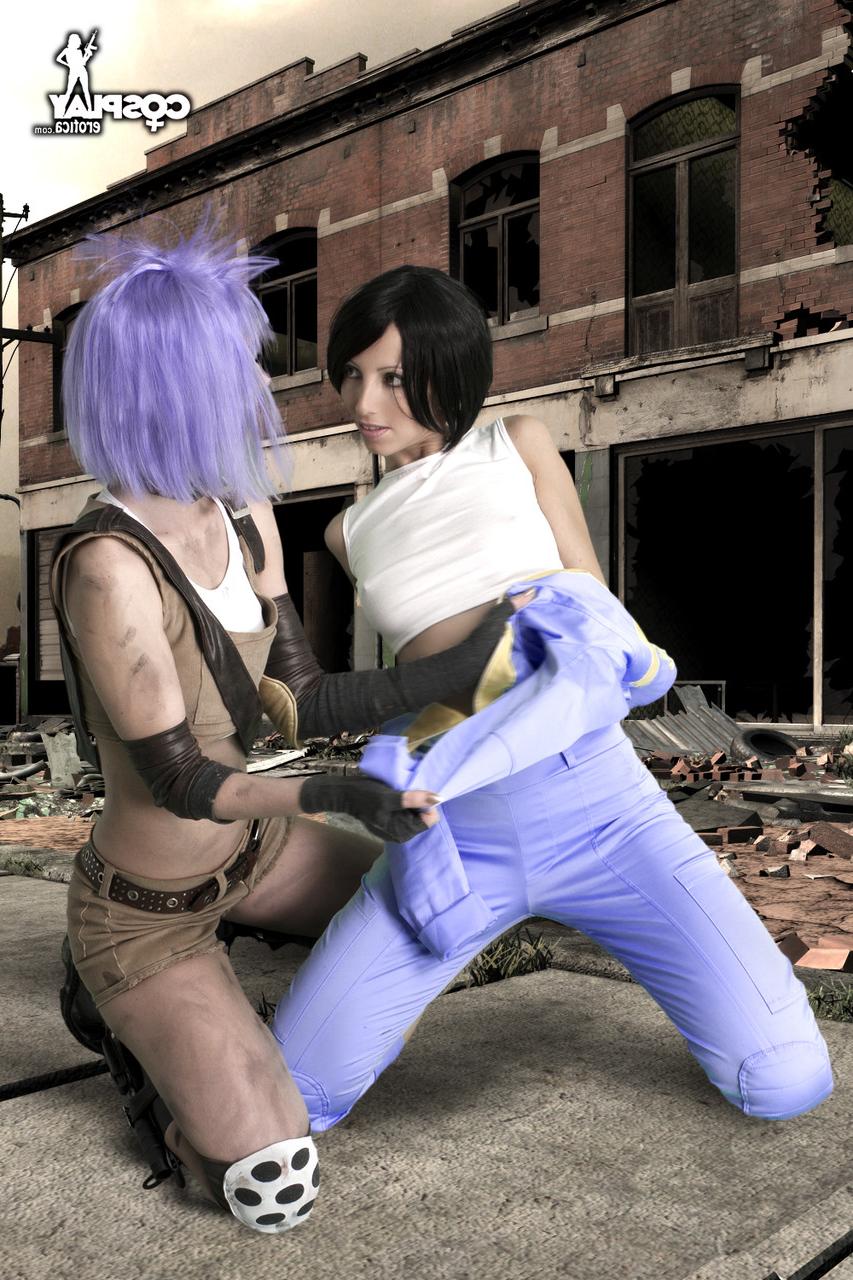 12P Lesbian cosplayers pause for a tongue kiss while holding their weapons