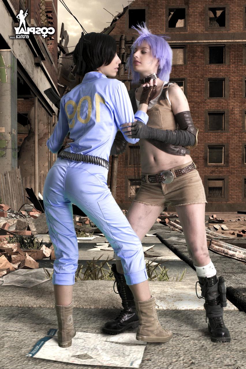 12P Lesbian cosplayers pause for a tongue kiss while holding their weapons