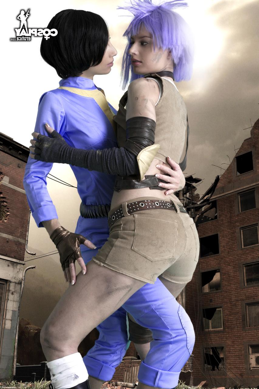 12P Lesbian cosplayers pause for a tongue kiss while holding their weapons