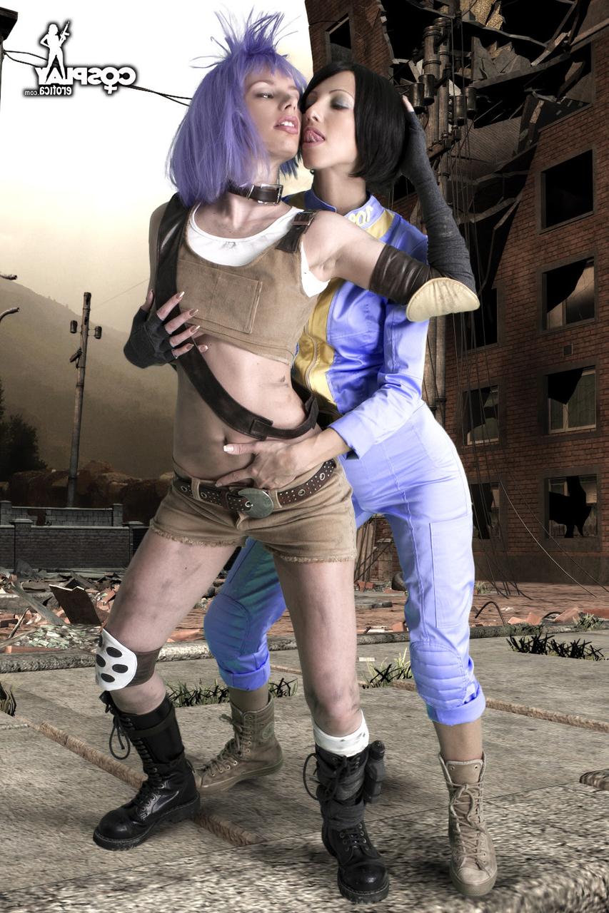 12P Lesbian cosplayers pause for a tongue kiss while holding their weapons