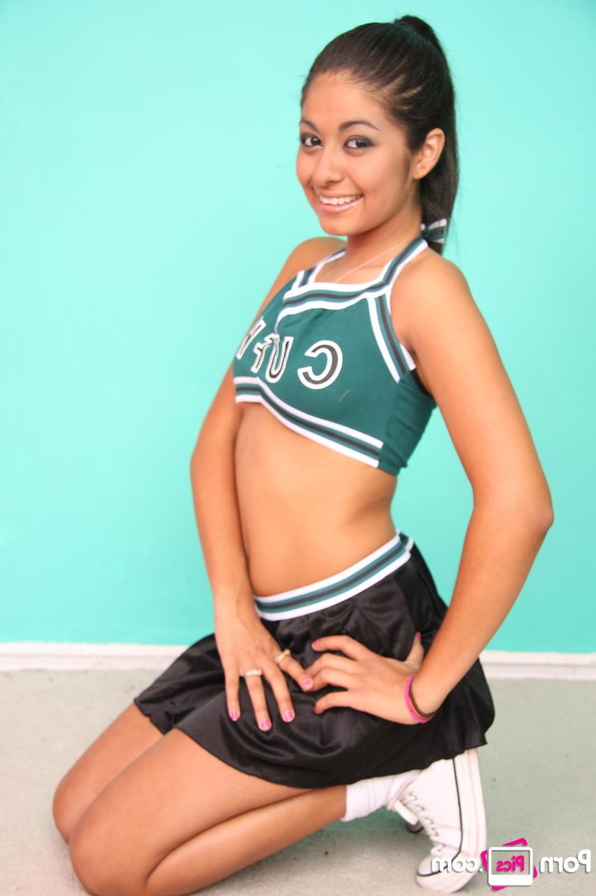20P Petite cheerleader Ruby Rayes exposes her titties and round ass and poses