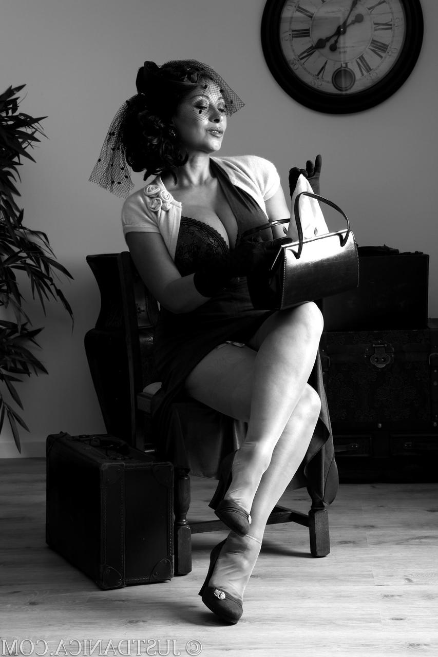 20P Elegant MILF Danica Collins strips to her lingerie and shows off her knockers