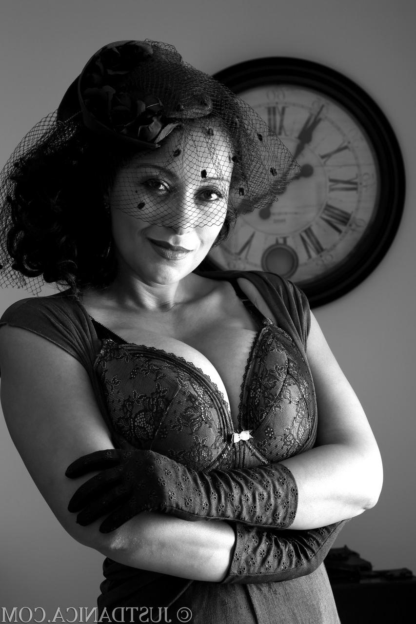 20P Elegant MILF Danica Collins strips to her lingerie and shows off her knockers