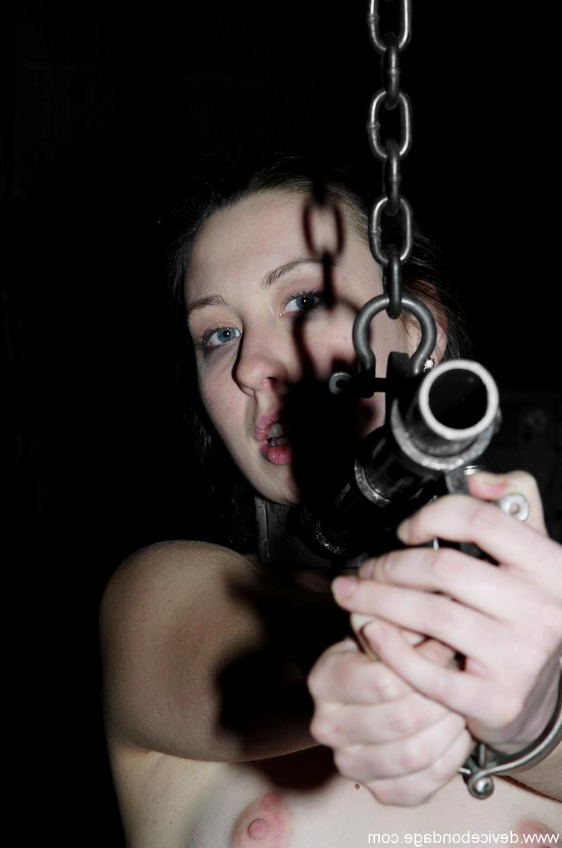 17P Brunette Alyssa in metal collar combined with handcuffs in the dark dungeon