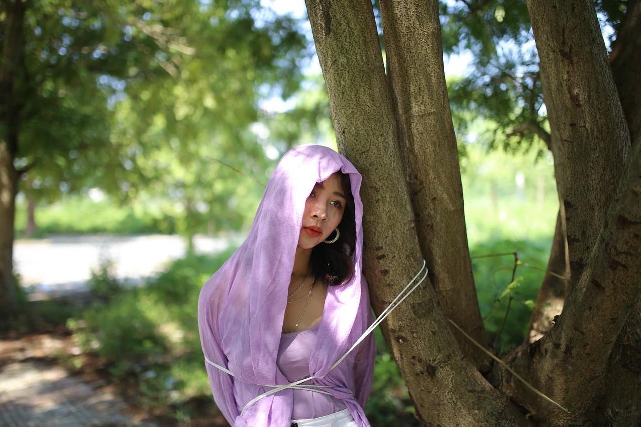 20P Asian seductress Nhatle posing in her amazing Halloween costume outdoors
