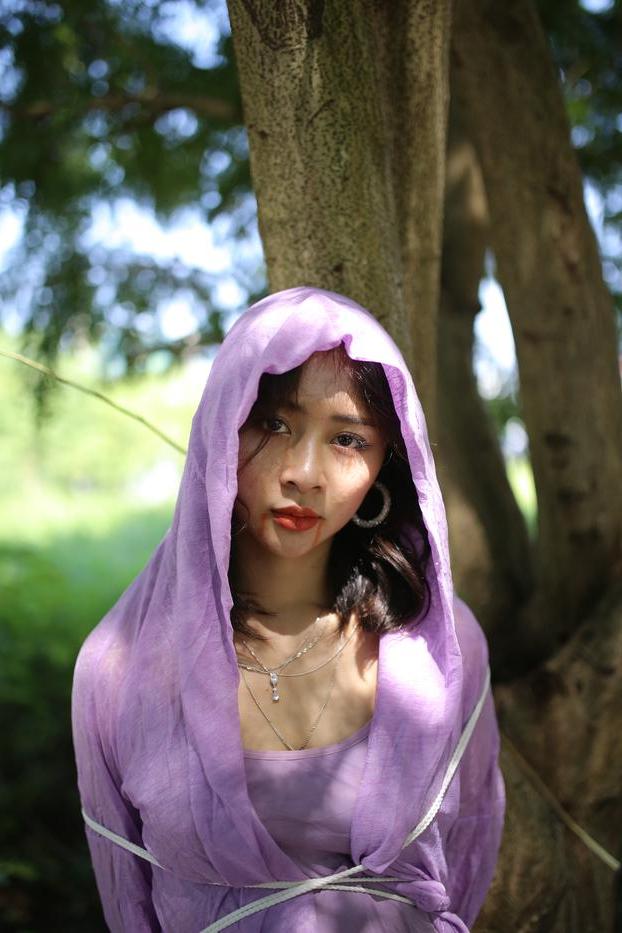 20P Asian seductress Nhatle posing in her amazing Halloween costume outdoors