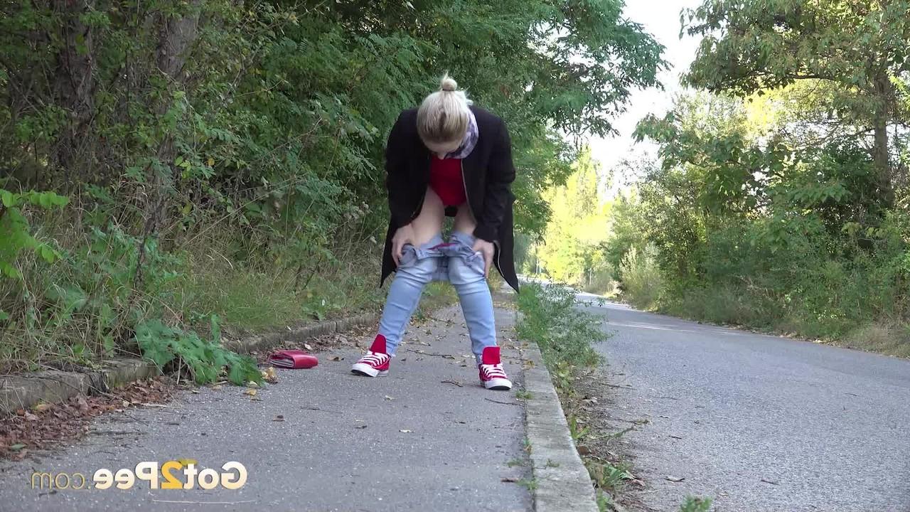 15P Pretty blonde Di Devi pulls down her jeans to pee on a public sidewalk