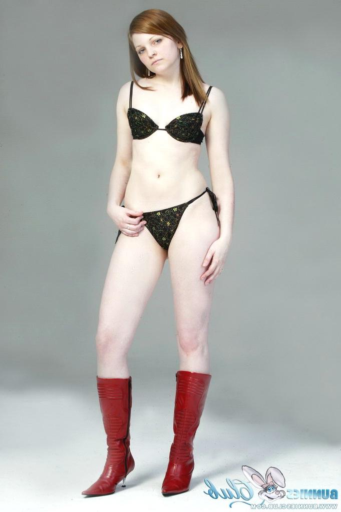 20P Pale redhead Lilly slowly strips to a black G-string and red leather boots