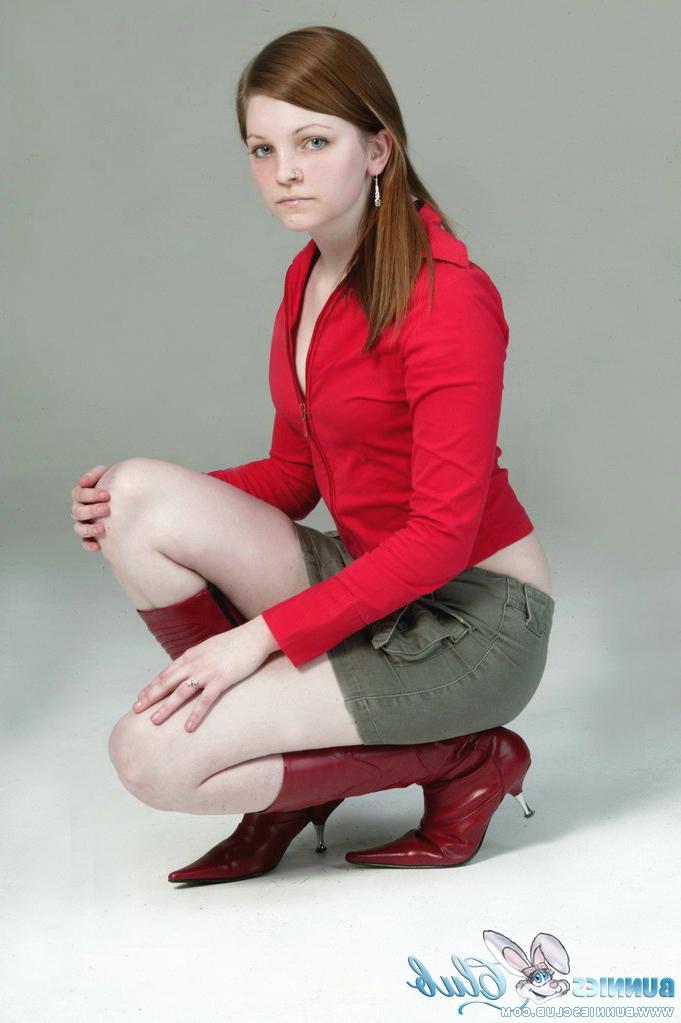 20P Pale redhead Lilly slowly strips to a black G-string and red leather boots