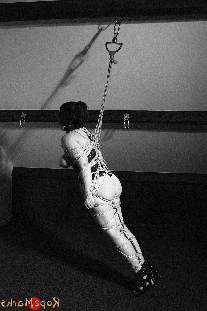 16P Hooded model Amely is tied and suspended by ropes in an attic setting