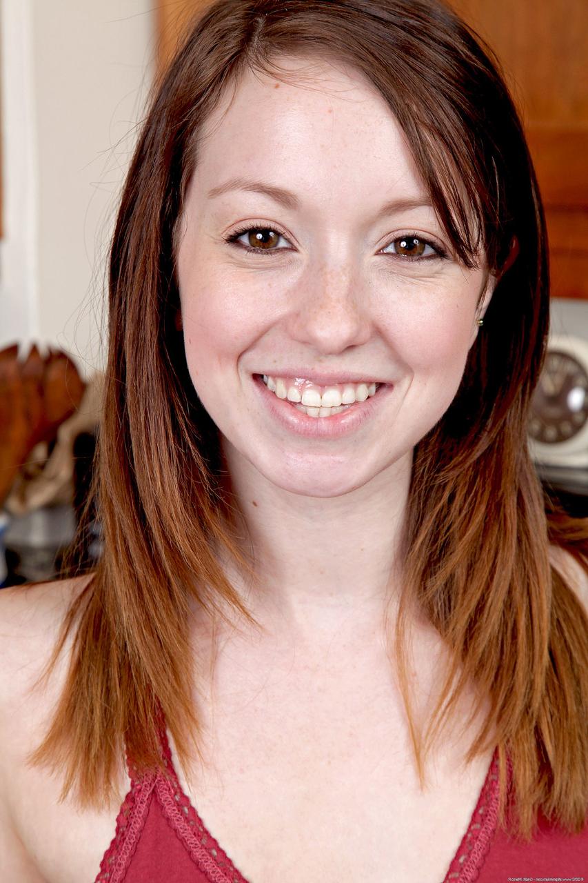 20P Cute ginger Ally Evans unveils her big tits and rubs her beaver in the kitchen