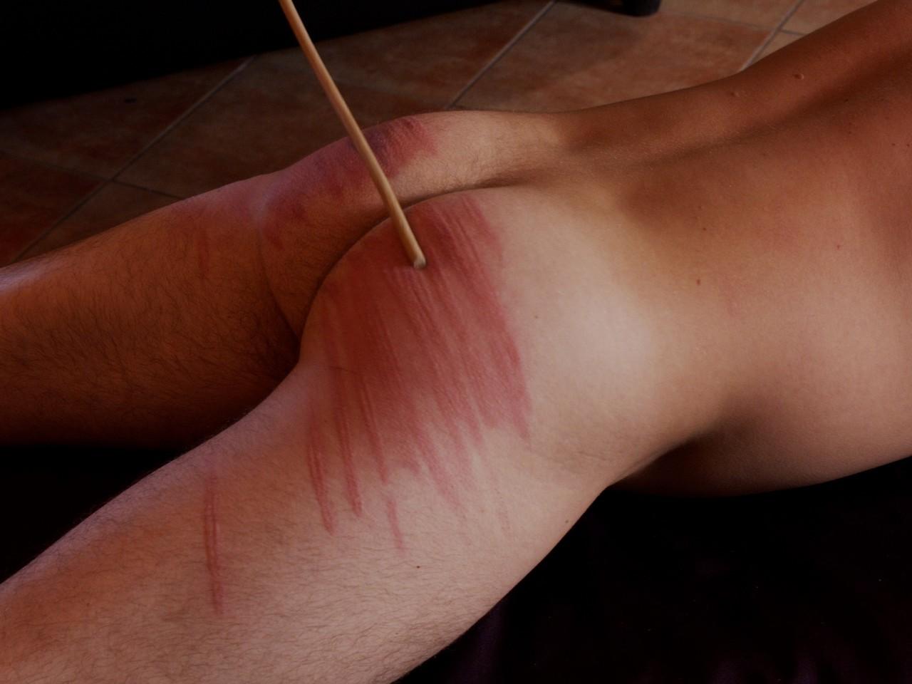 10P Nasty domme in a latex dress canes a tied up masked man hard in BDSM action