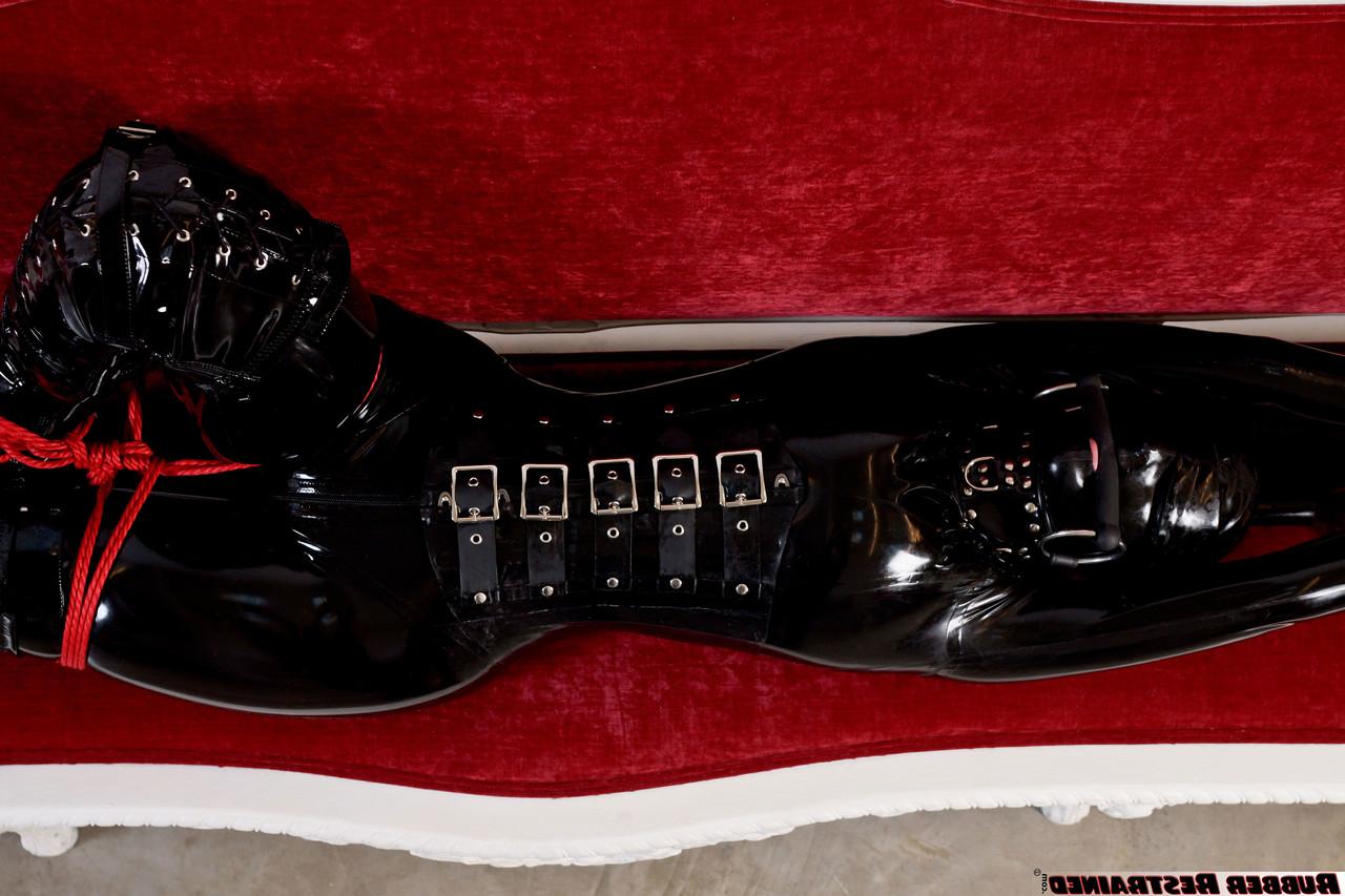 16P Natural redhead is tied up on a sofa while wearing head to toe latex attire