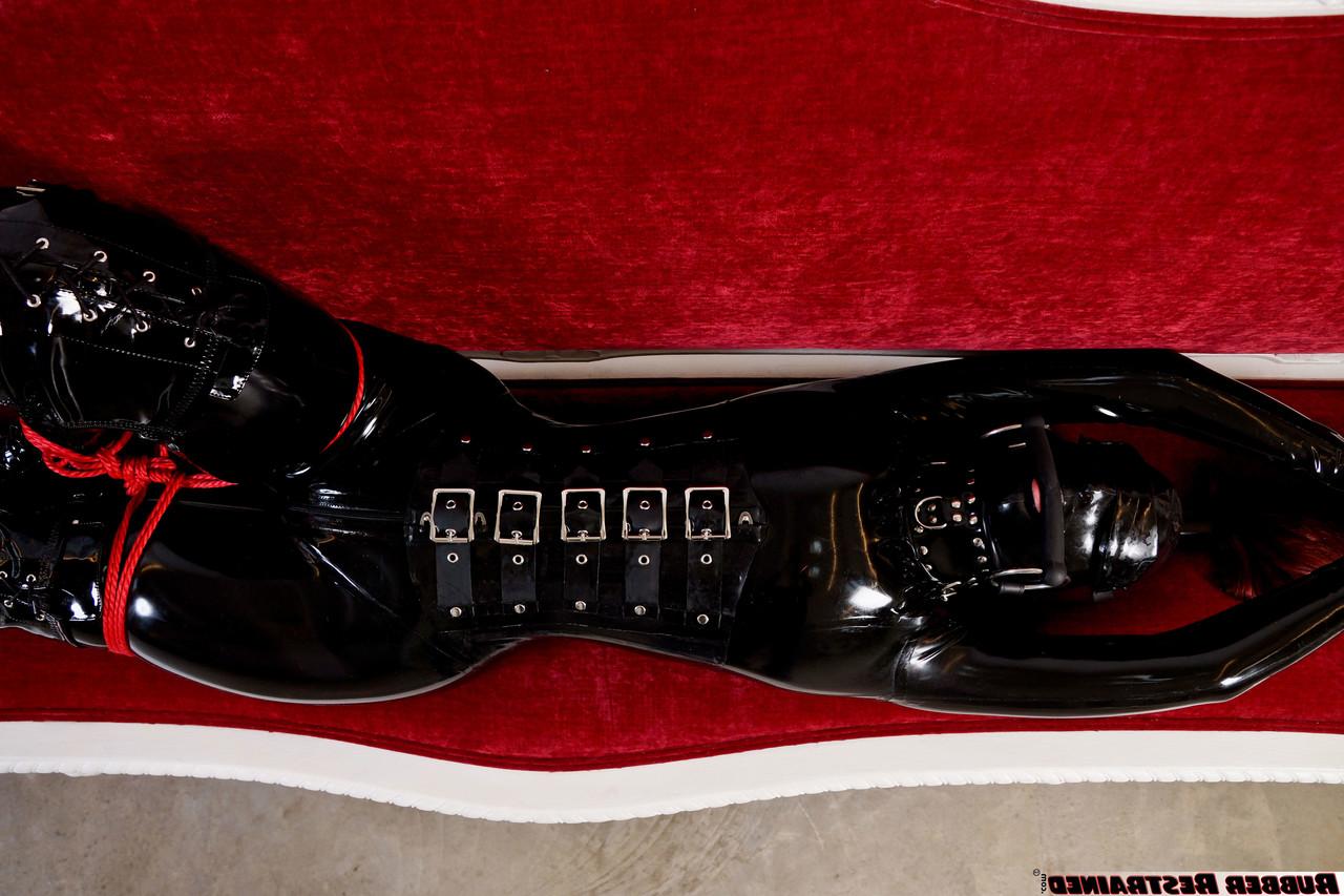 16P Natural redhead is tied up on a sofa while wearing head to toe latex attire