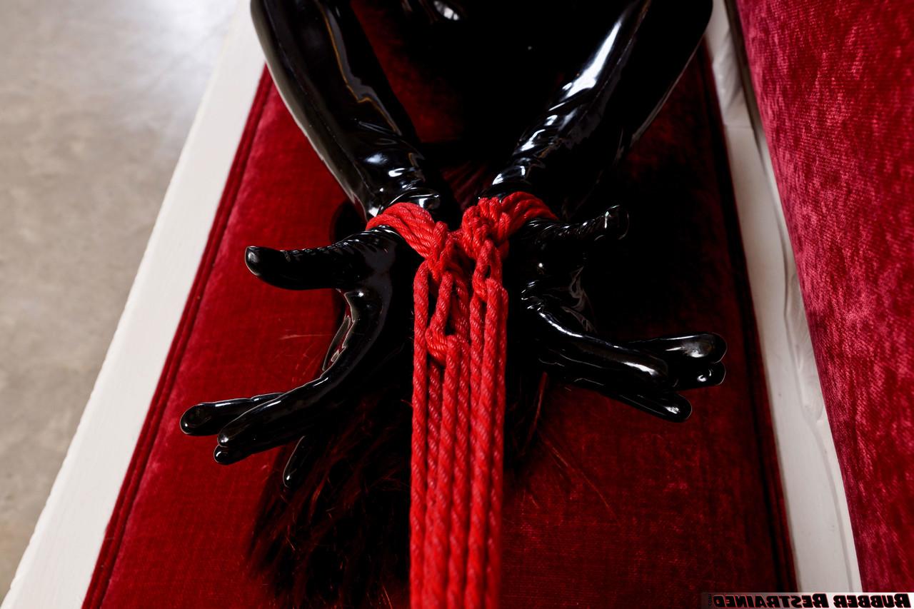 16P Natural redhead is tied up on a sofa while wearing head to toe latex attire