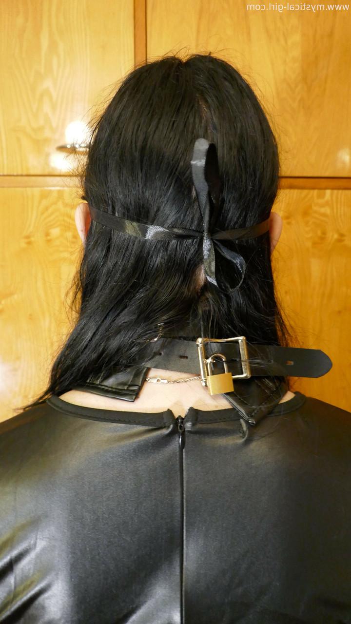 16P Caucasian woman sports a mask while modelling leather clothing and footwear